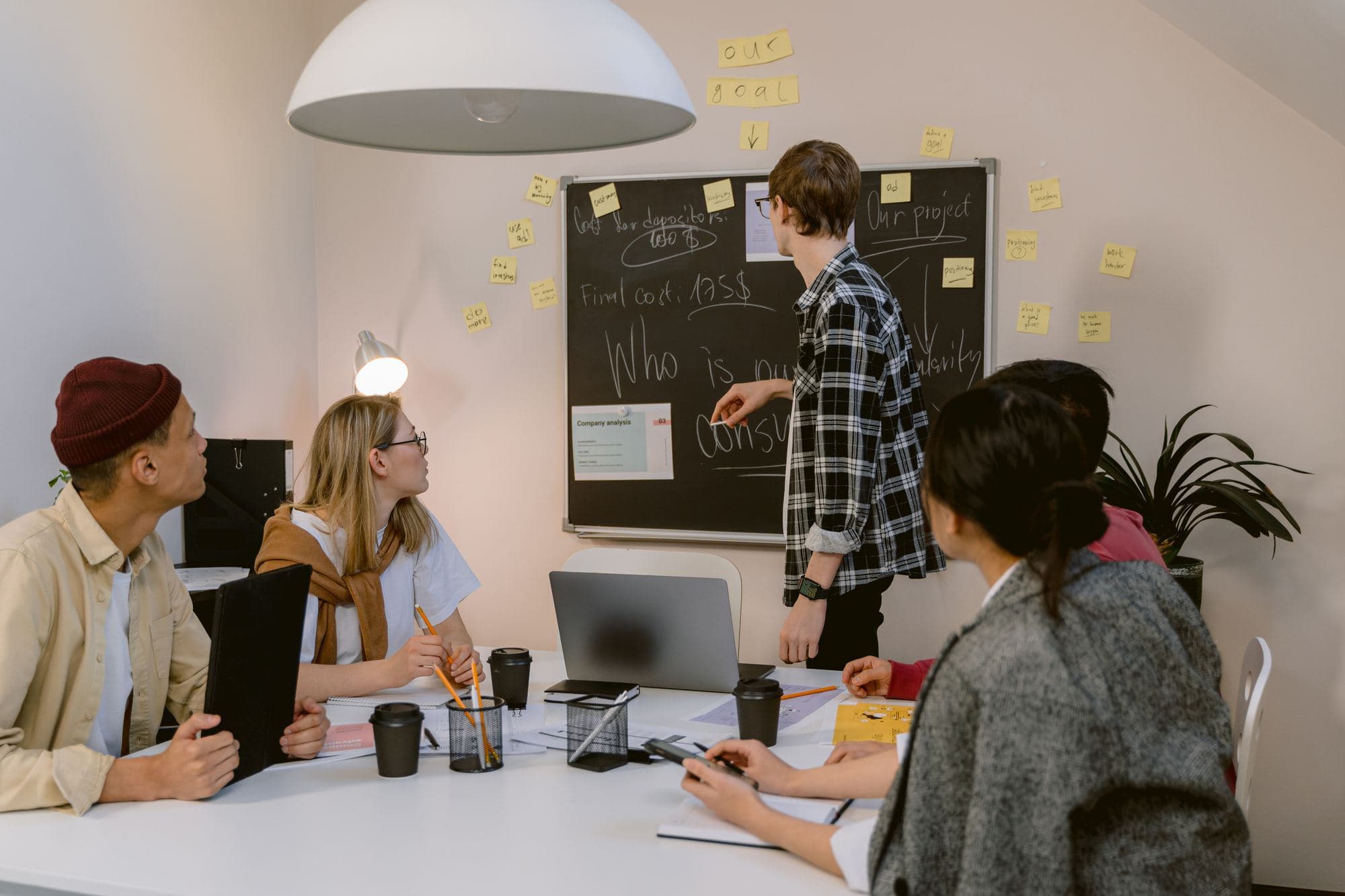 A team brainstorming around a whiteboard in a modern office