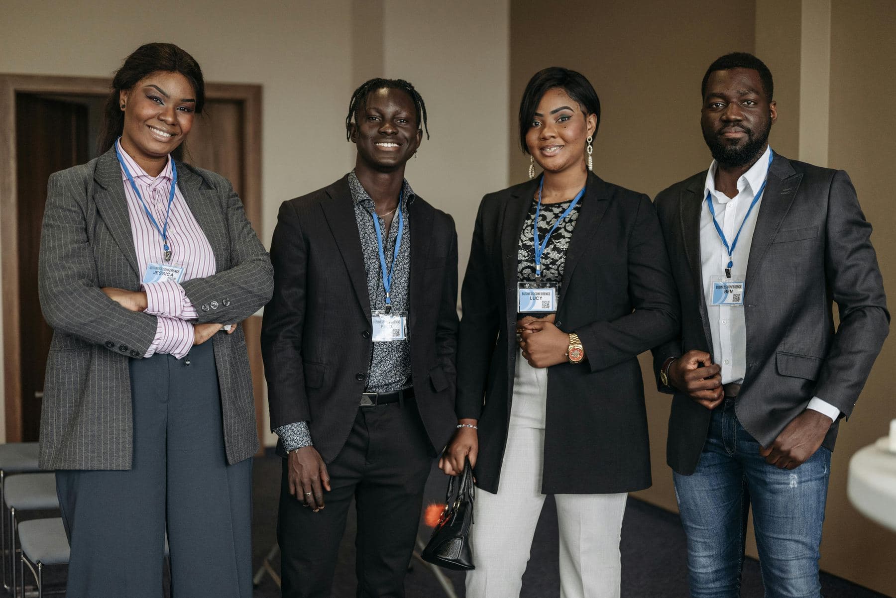 Four young professionals standing together in an office
