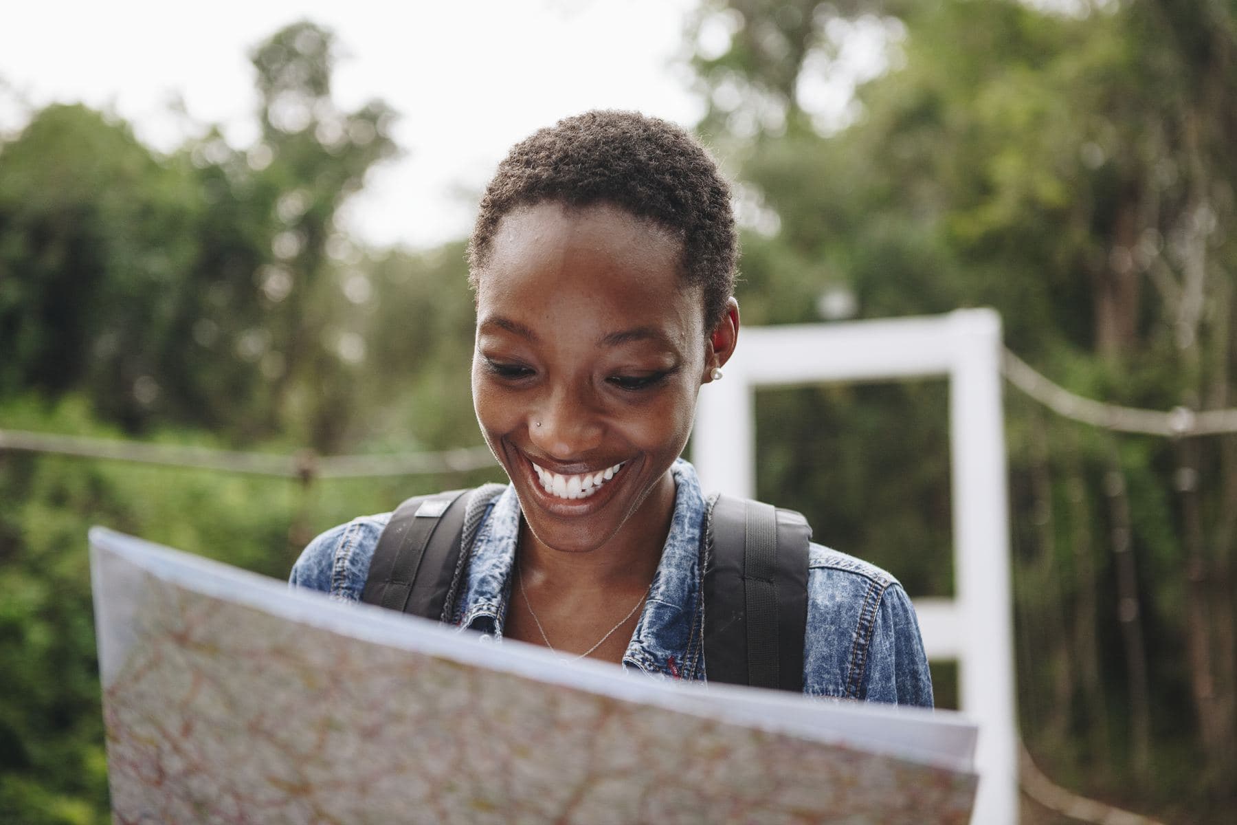 Young woman reading a map outdoors