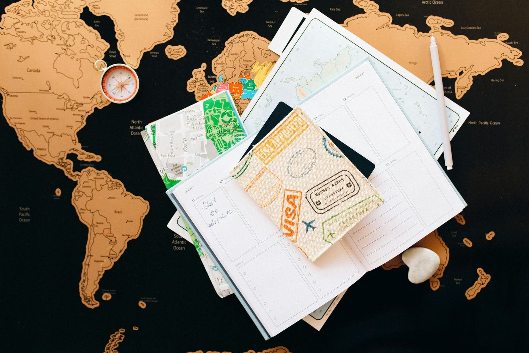 Passport, visa documents and a world map